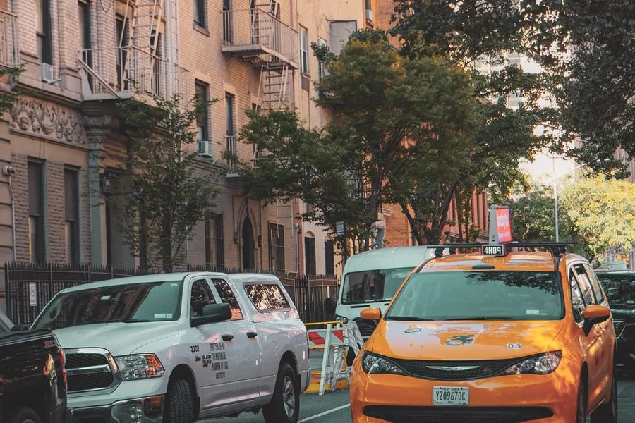 Yellow taxi cab driving in New York City street traffic
