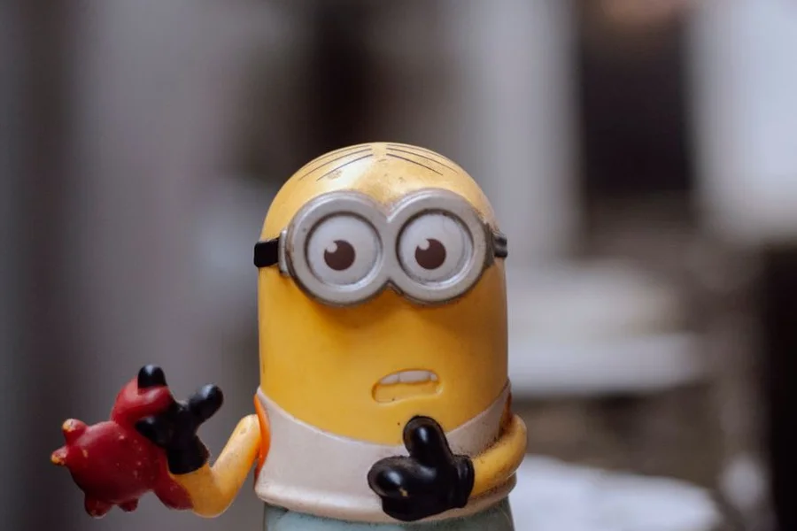 Yellow sponge toy figurine with a funny face