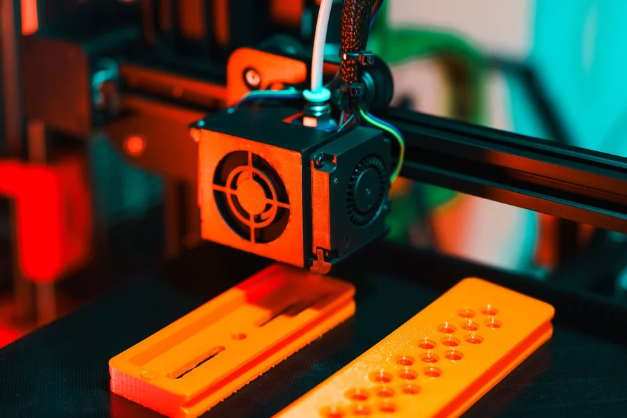 A 3D printer printing custom plastic shapes