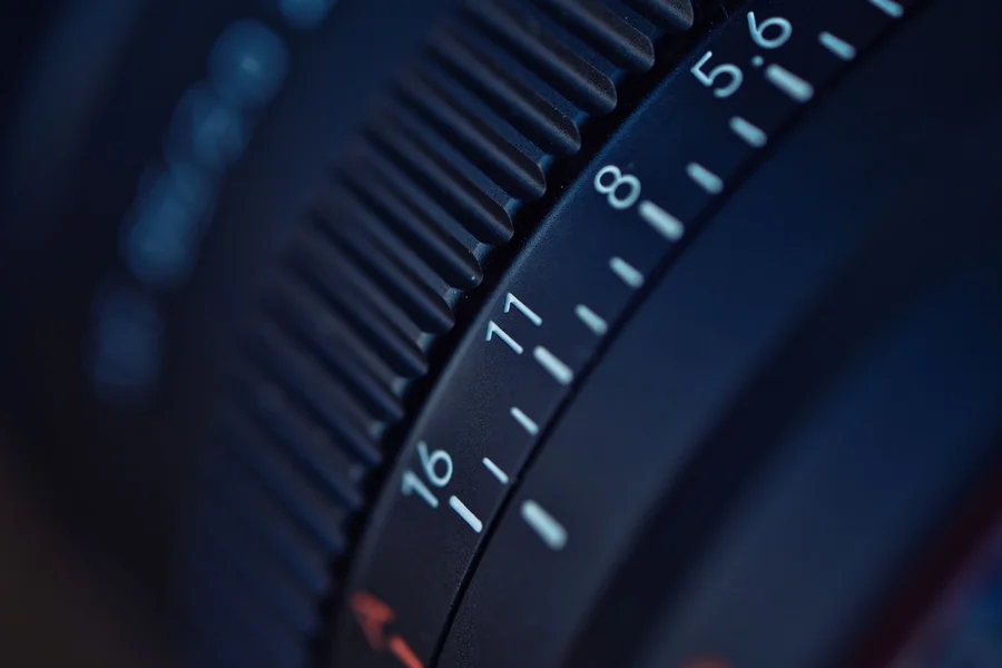 Close up of adjusting the focus ring on a cinema camera lens