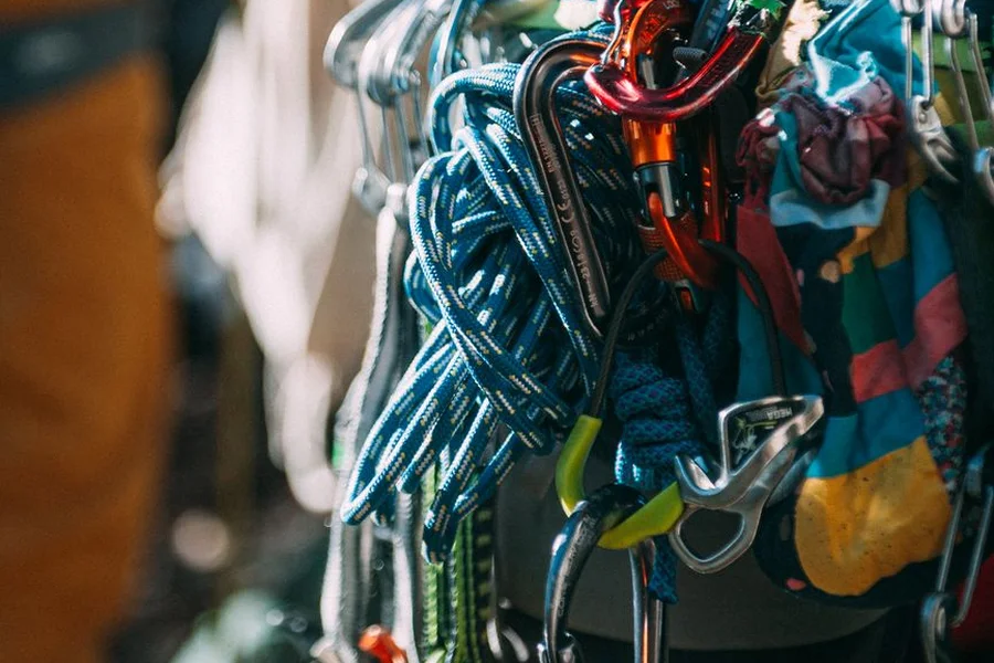 Mountaineering safety ropes, harness, carabiners, and climbing gear on rock