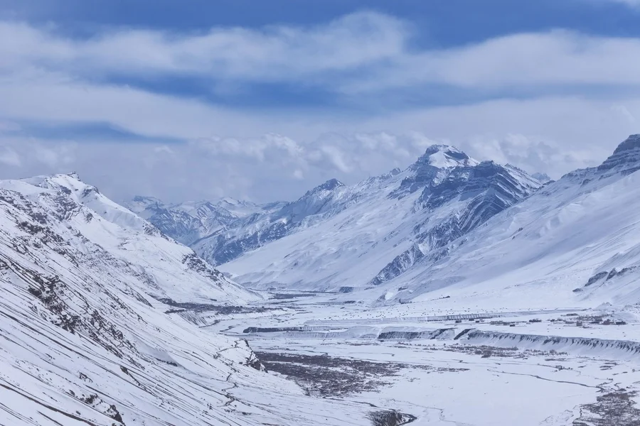 High altitude snow mountain valley and glacier in China under a blue sky