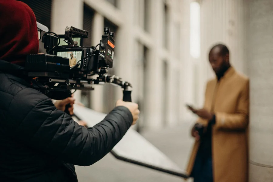 Director using a mirrorless camera on a cinema set