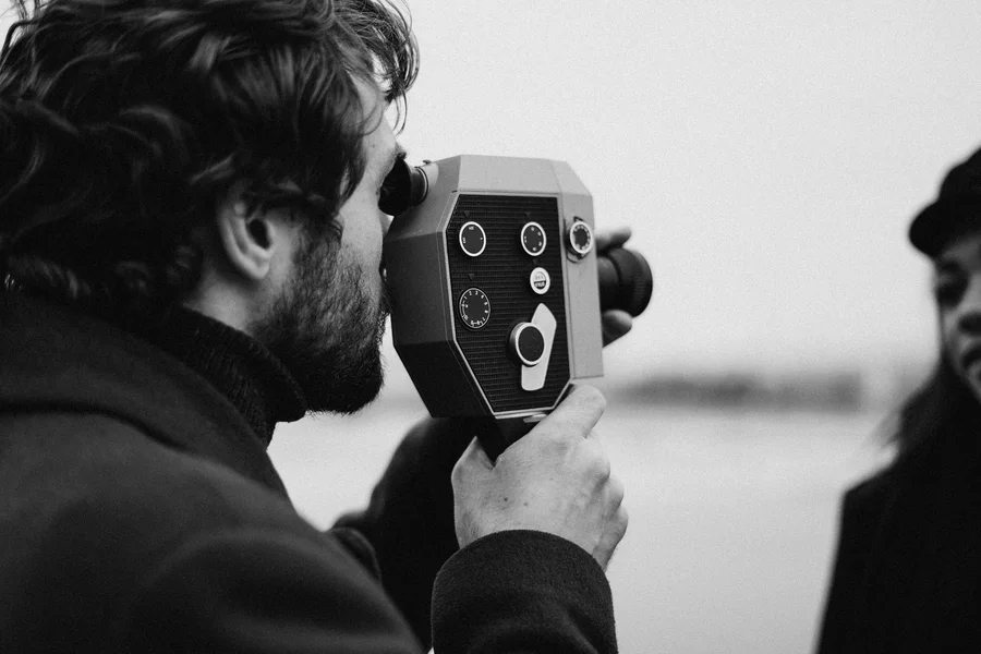 Vintage black and white movie camera with film spools