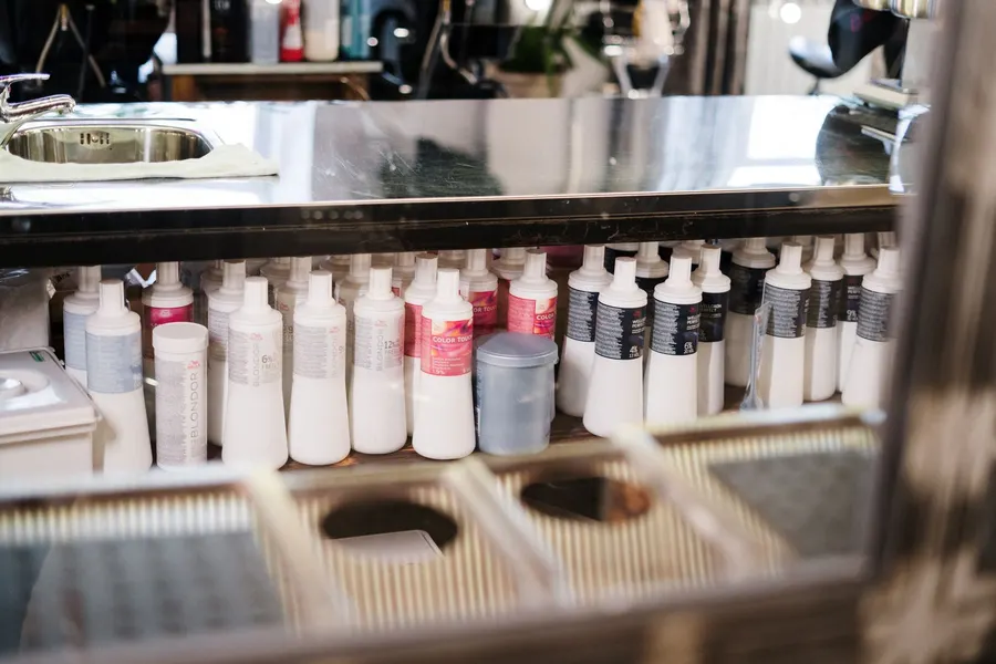 Organized hair salon retail shelves lined with professional shampoo and styling bottles