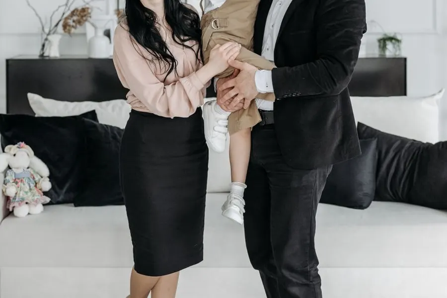 Happy parents holding their newly adopted child in a living room in Columbia SC